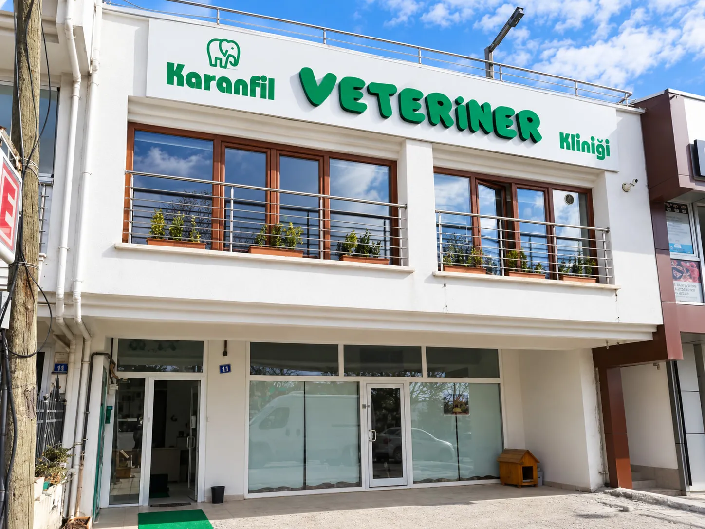 The green shopfront sign of Karanfil Veterinary Clinic.